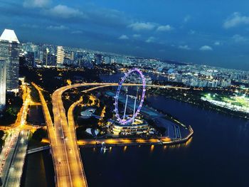 High angle view of illuminated city against sky at night