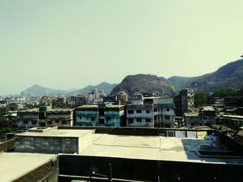 Buildings in town against clear sky