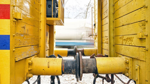 Close-up of yellow pipes in factory