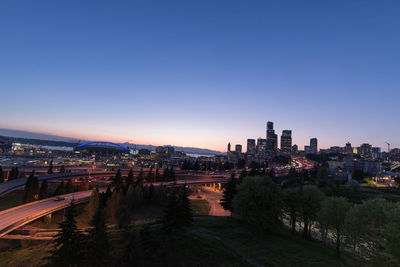 High angle view of buildings against clear sky at sunset