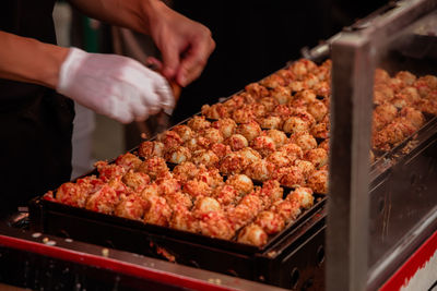 Midsection of man preparing food at market