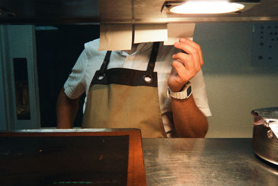 Cropped hand of man working on table