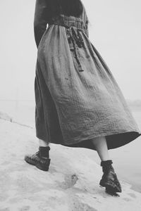 Low section of woman standing on beach