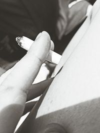 Close-up of hand holding cigarette