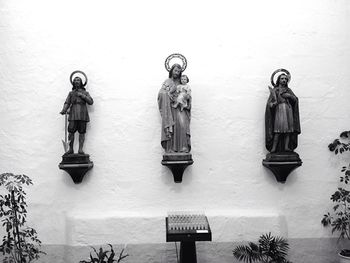 Statue of buddha against wall