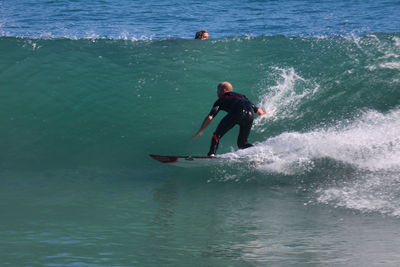 Full length of man surfing in sea