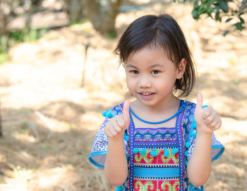 4 years old cute baby asian girl, little preschooler child smiling and looking at camera.