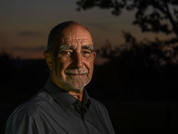 Portrait of young man against black background