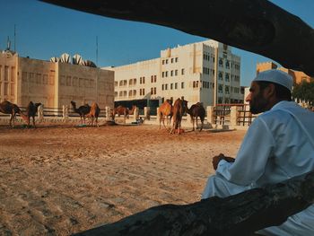 Rear view of man walking on city street