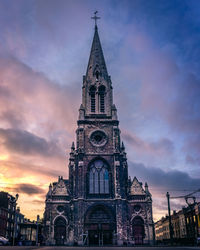 Low angle view of eglise saint-servais against cloudy sky