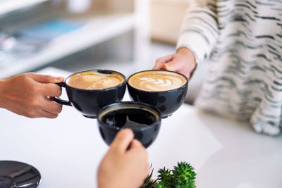 Midsection of woman holding coffee cup