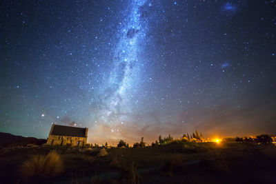 Scenic view of illuminated building against sky at night