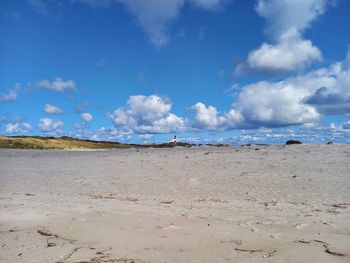 Scenic view of beach against blue sky