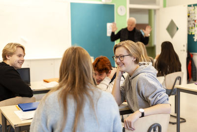 Teenage kids and teacher in classroom