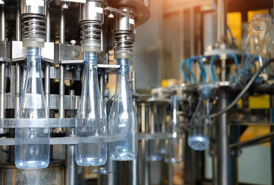 Close-up of glass bottles in factory
