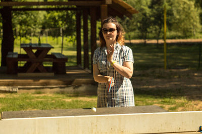 Mid adult woman playing table tennis at park