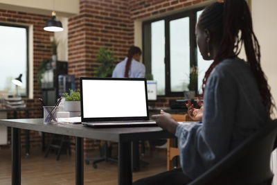 Young woman using laptop at office