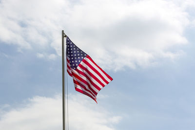 Low angle view of american flag against sky