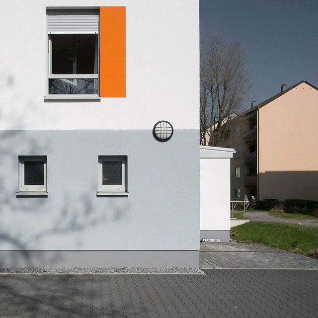 building exterior, architecture, built structure, window, house, residential building, bare tree, wall - building feature, residential structure, day, building, door, outdoors, wall, tree, no people, shadow, city, sunlight, sky