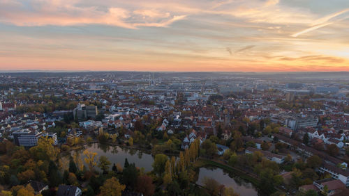 Aerial view of cityscape against sky during sunset