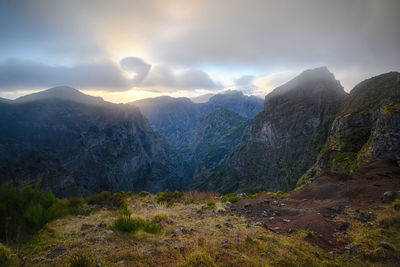 Scenic view of mountains against cloudy sky