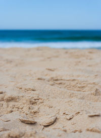 Close-up of sand on beach against sky