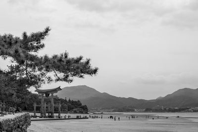 Scenic view of building by mountains against sky