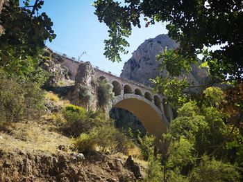 Low angle view of arch bridge against sky