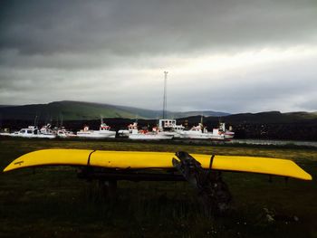 Boat in sea against cloudy sky