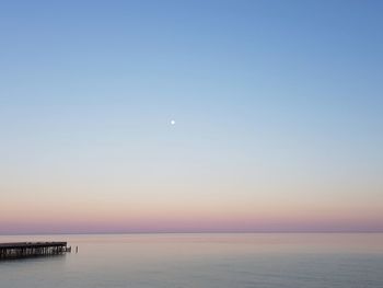 Scenic view of sea against sky at sunset