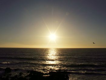 Scenic view of sea against sky at sunset