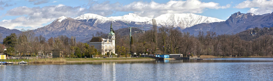 Scenic view of lake and snowcapped mountains against sky