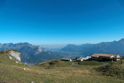 Scenic view of mountains against clear blue sky