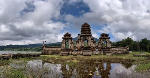 Exterior of temple by building against sky