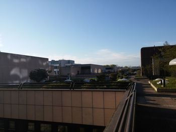 Buildings in city against blue sky