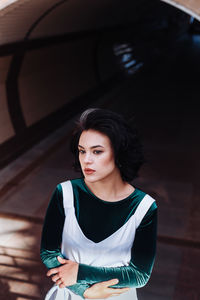 Fashionable woman looking away while standing outdoors 