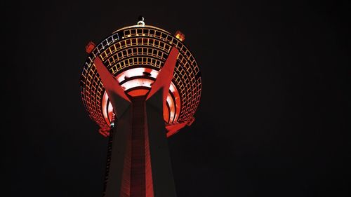 Low angle view of illuminated west pearl tower against clear sky