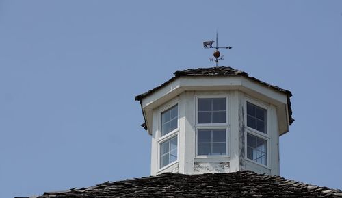 Low angle view of built structure against clear blue sky