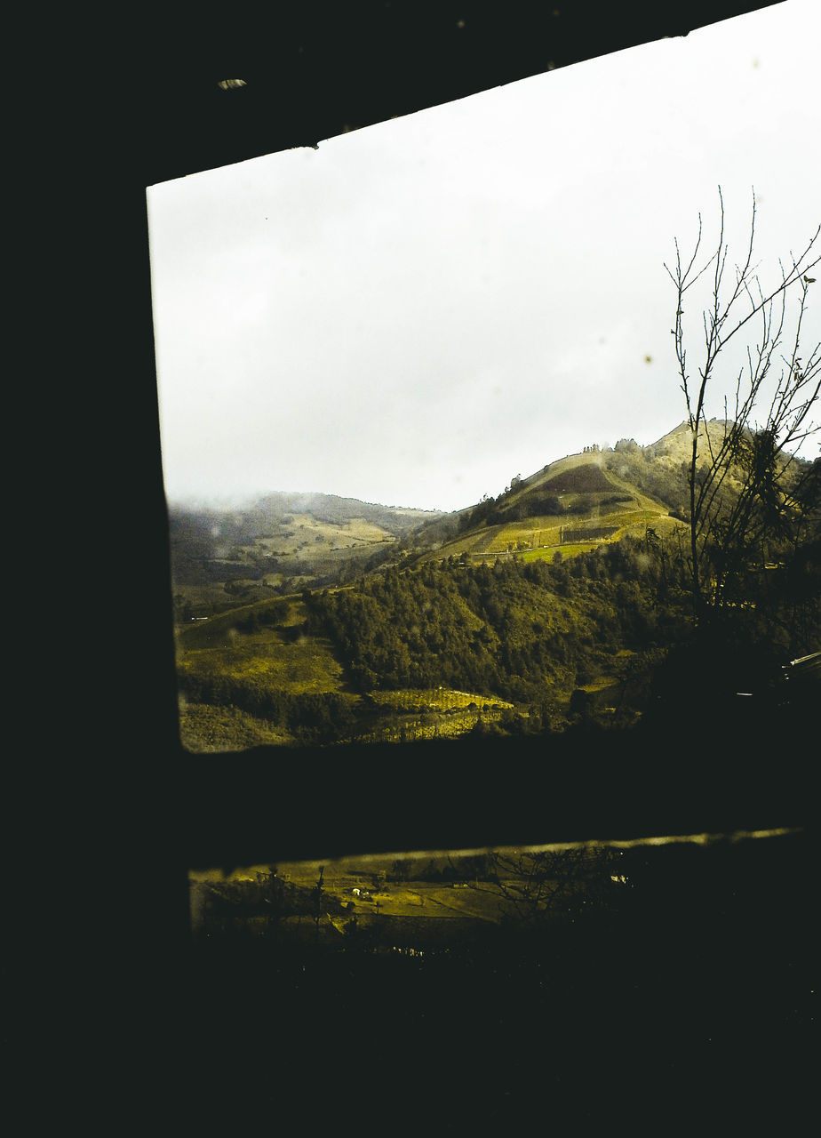 SCENIC VIEW OF LANDSCAPE SEEN THROUGH WINDOW