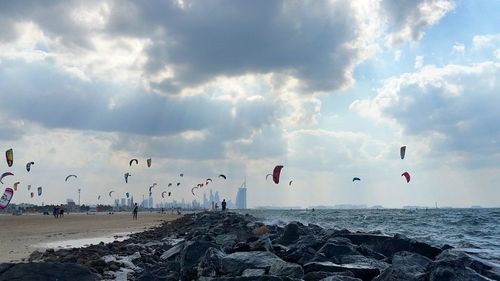 People on beach against sky