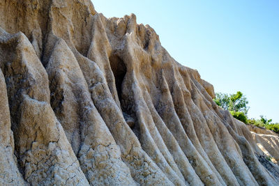 Low angle view of rock formation against sky