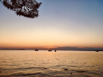 Scenic view of sea against clear sky during sunset