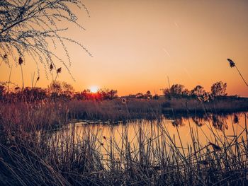 Scenic view of lake against sky during sunset