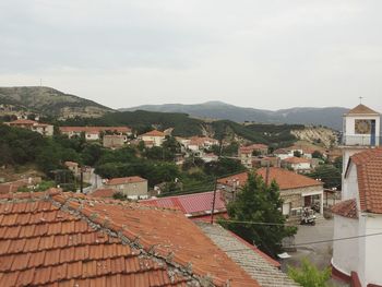 High angle view of houses in town against sky