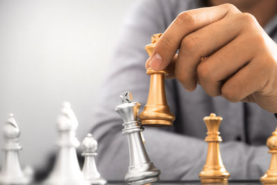 Close-up of hand holding chess pieces