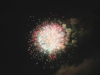 Low angle view of firework display at night