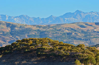 Scenic view of mountains against clear blue sky