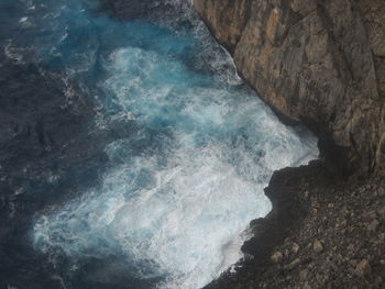 High angle view of rocks in sea