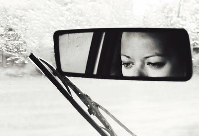 Close-up portrait of young woman sitting in car