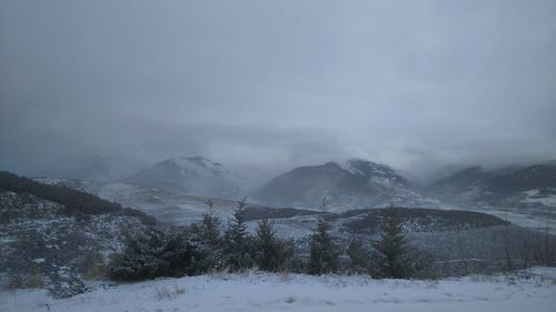 Scenic view of snow covered mountains against sky